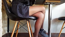 Sexy legs in shiny black pantyhose