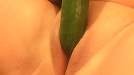 Trying to take an extra large cucumber!